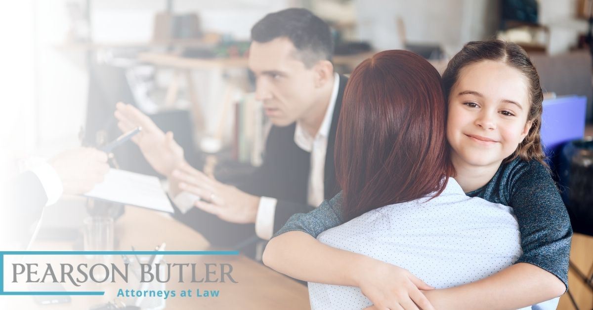 Daughter hugging mother while father talks in the background